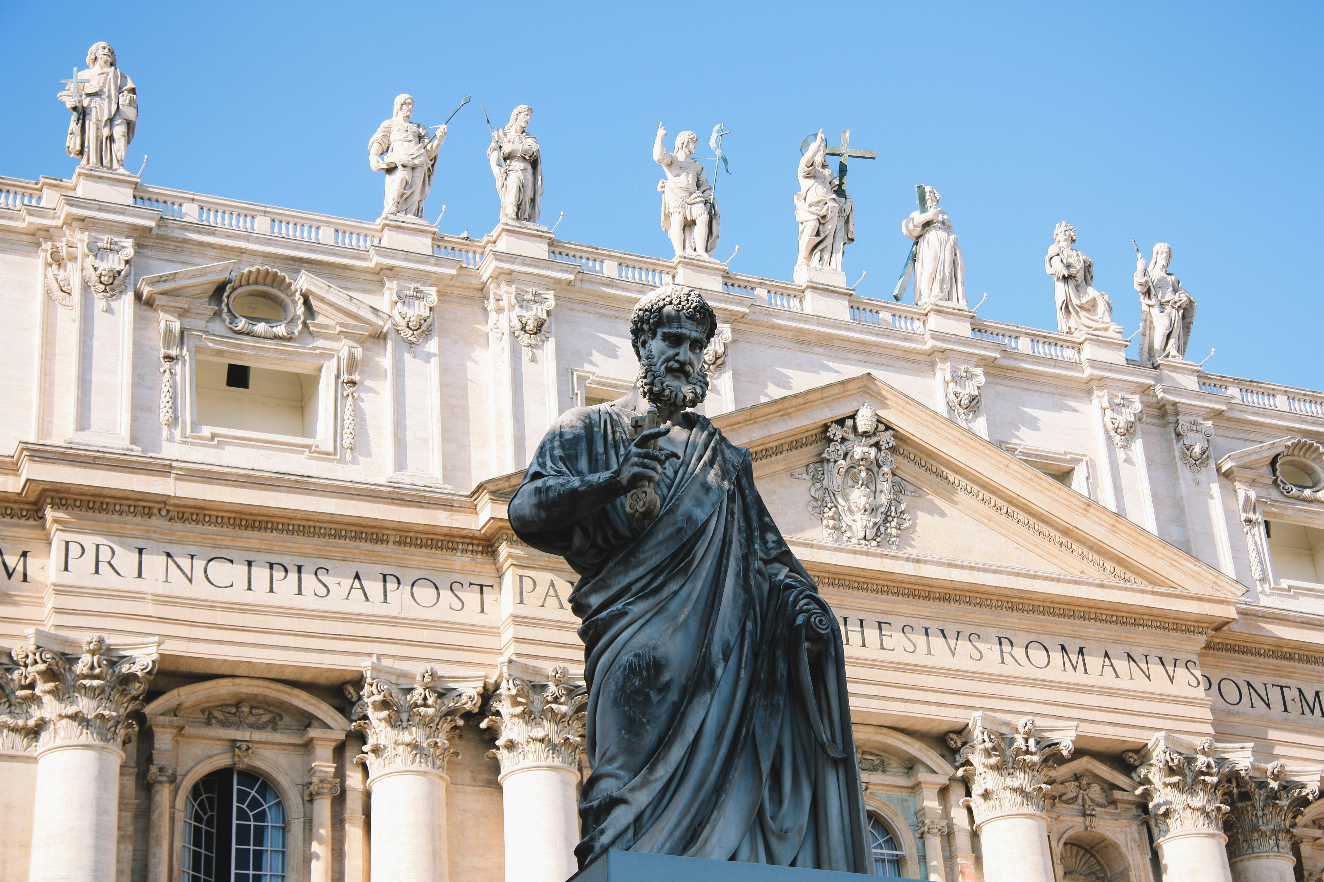 man statue beside concrete building during daytime